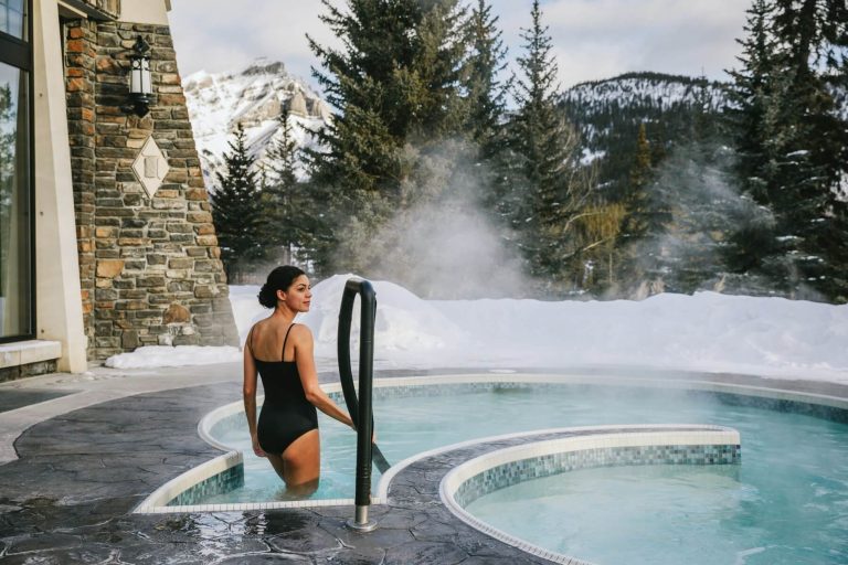 Outdoor pool in winter with a girl next to it