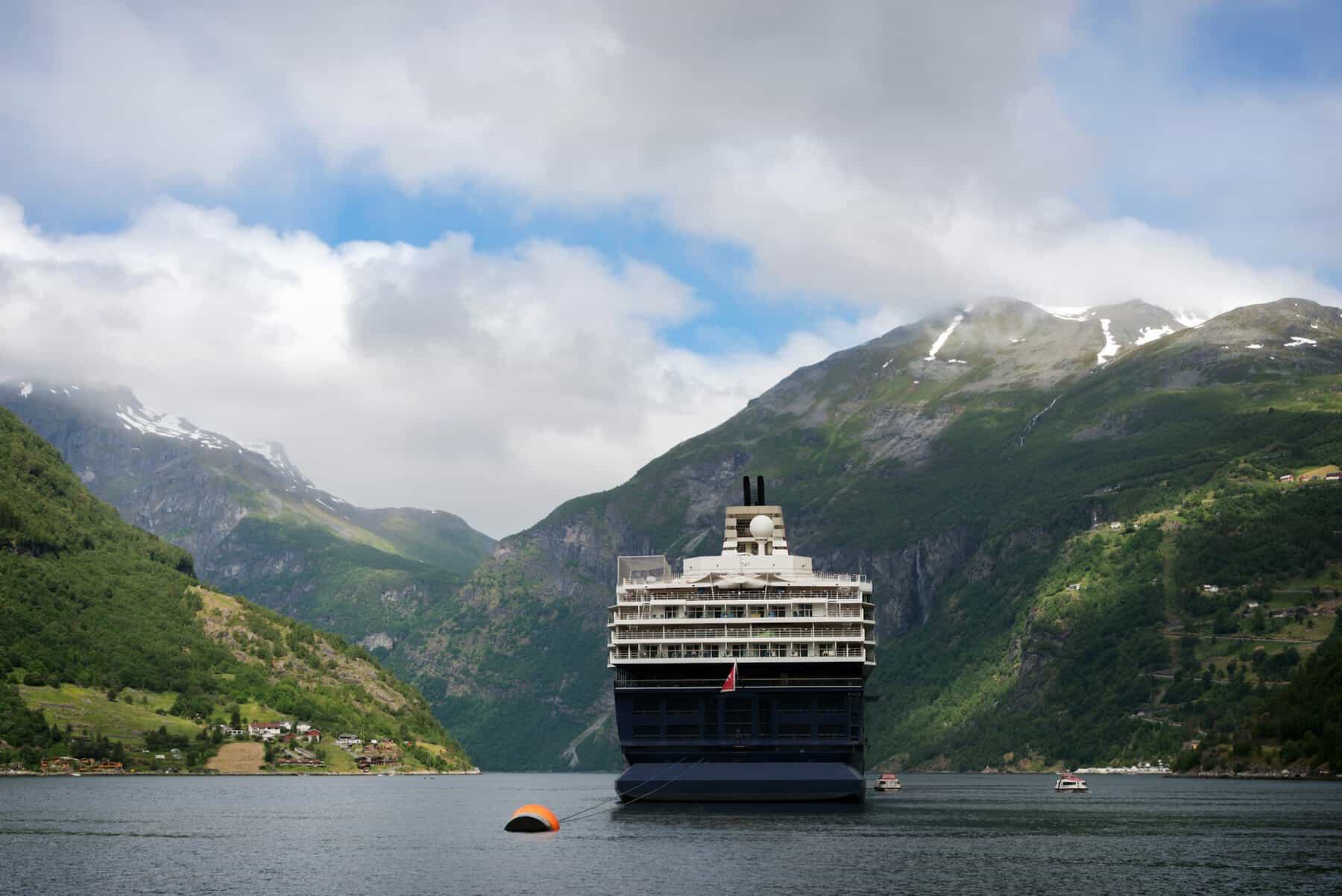 Cruise ship in narrow Geiranger fjord in Norway